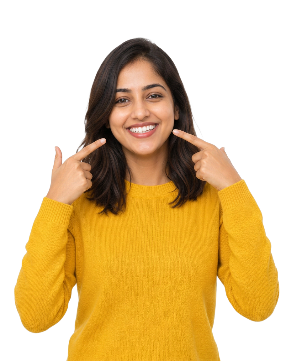 Smiling patient in yellow sweater pointing to her bright smile at N Square Dental Clinic